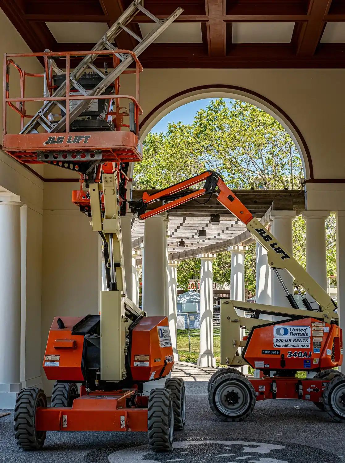 Certified technicians installing lighting at height with safety equipment