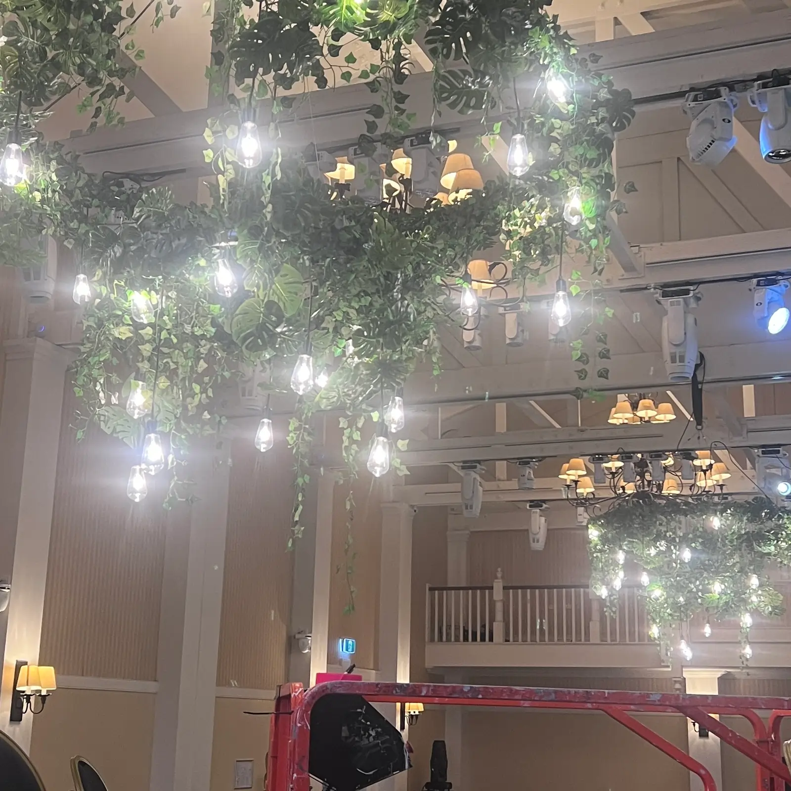 Elegant crystal chandeliers hanging from marquee ceiling creating luxury atmosphere for high-end weddings.