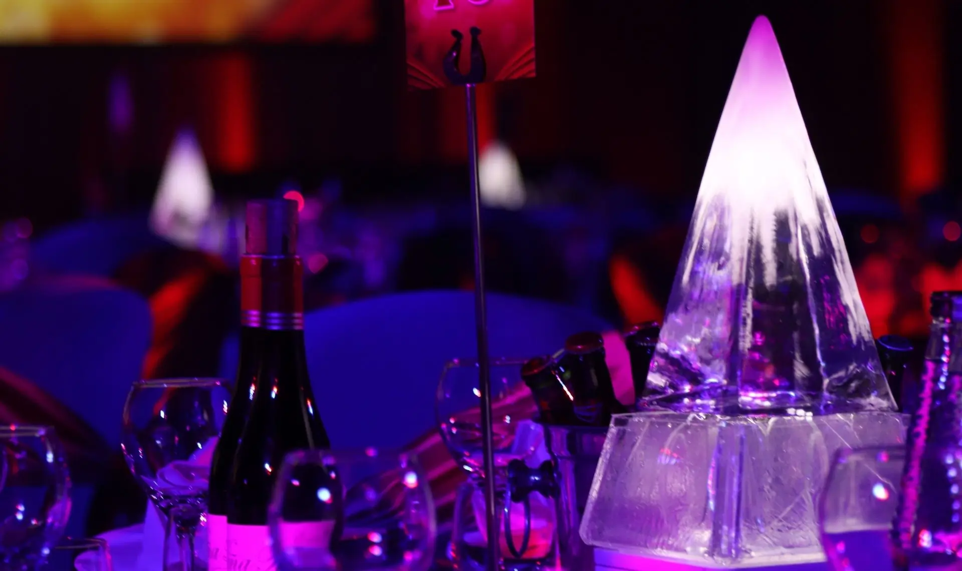 Intricate table centerpieces with integrated LED lighting highlighting floral arrangements for wedding receptions.