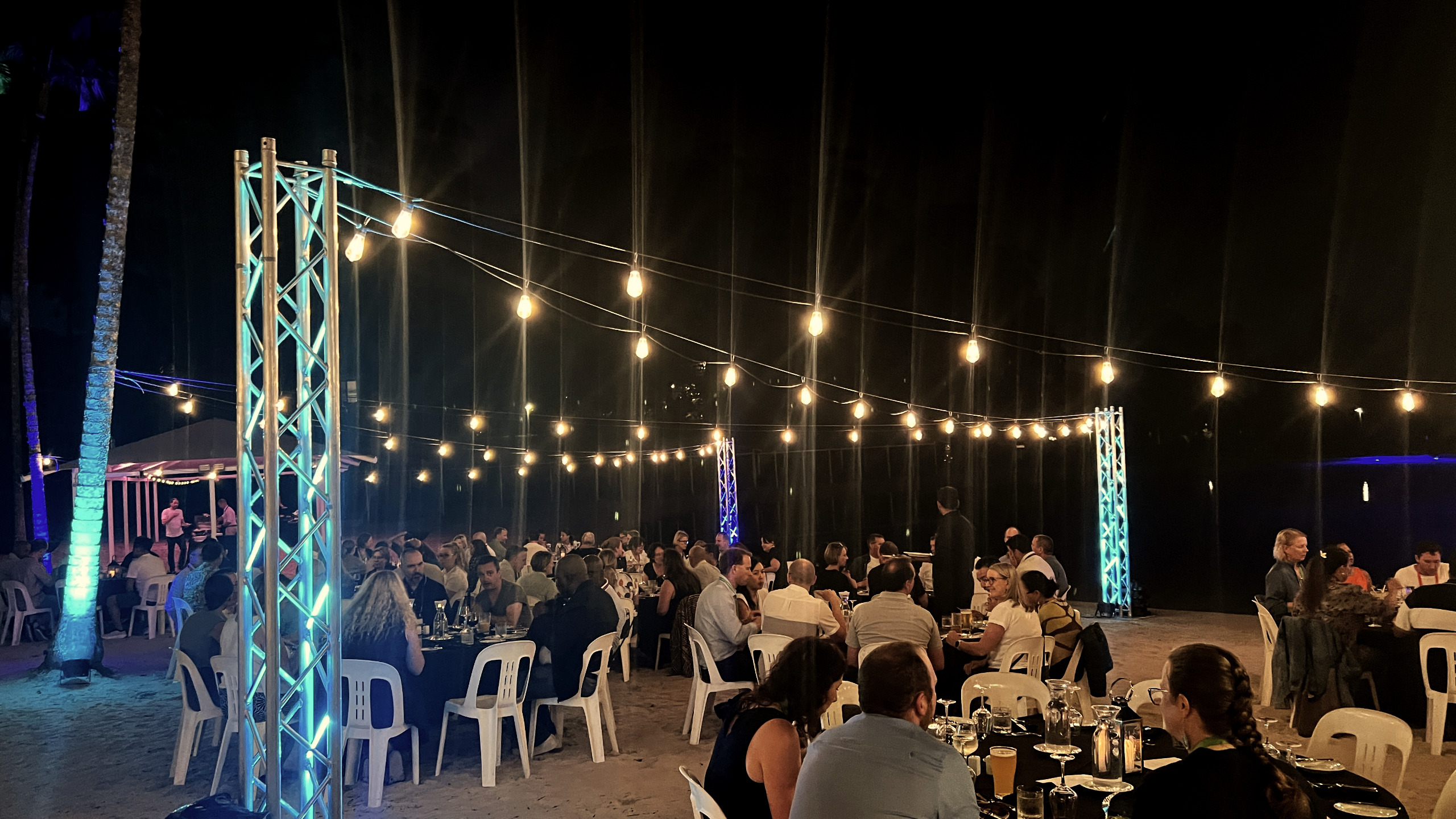 Festoon lighting strung over an outdoor event